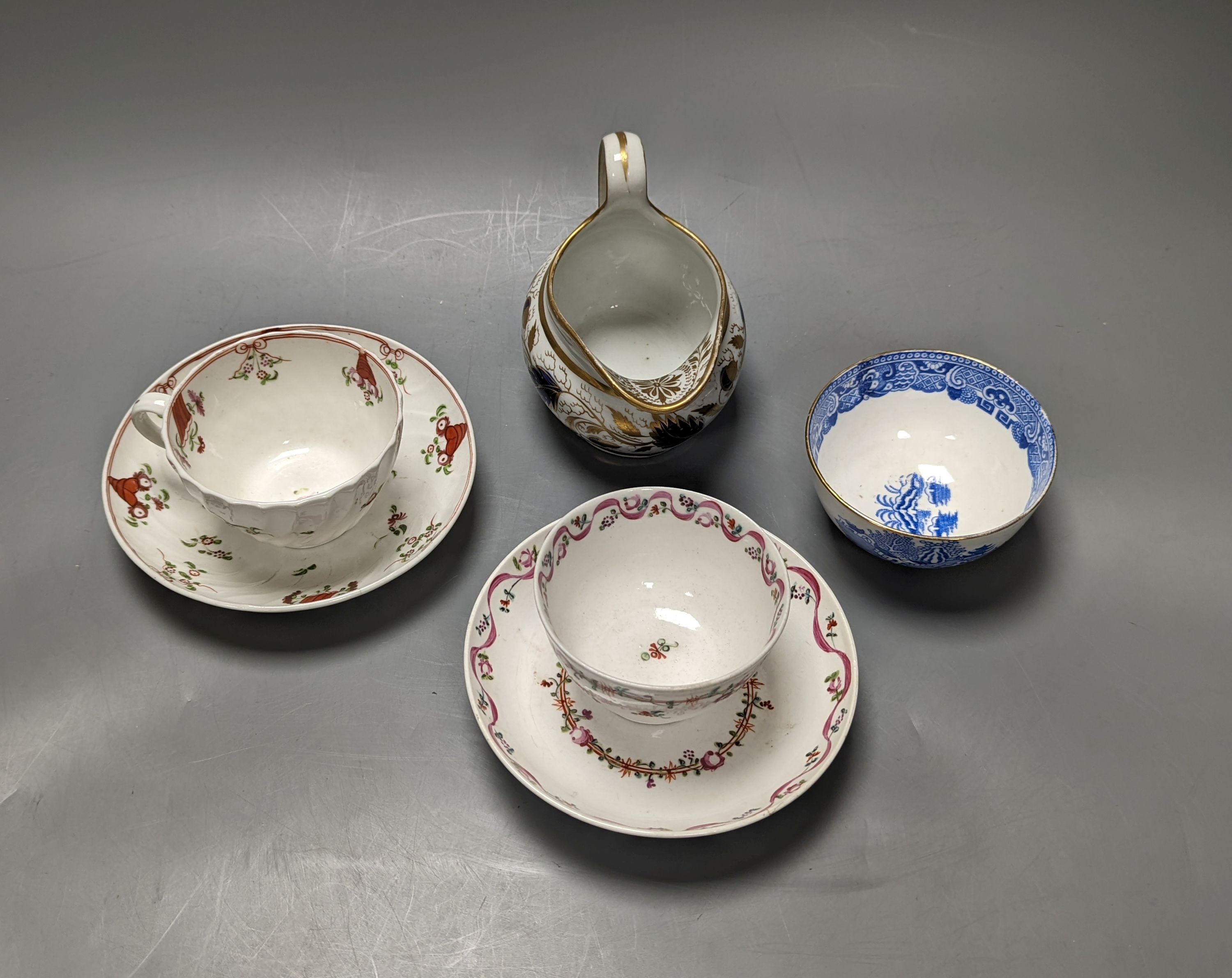 New Hall style study collection: a cream jug pattern 524, a teabowl and saucer with oriental figures, and another teabowl and saucer, a shankered teacup and saucer, two coffee cups, three teabowls, four saucers and a slo